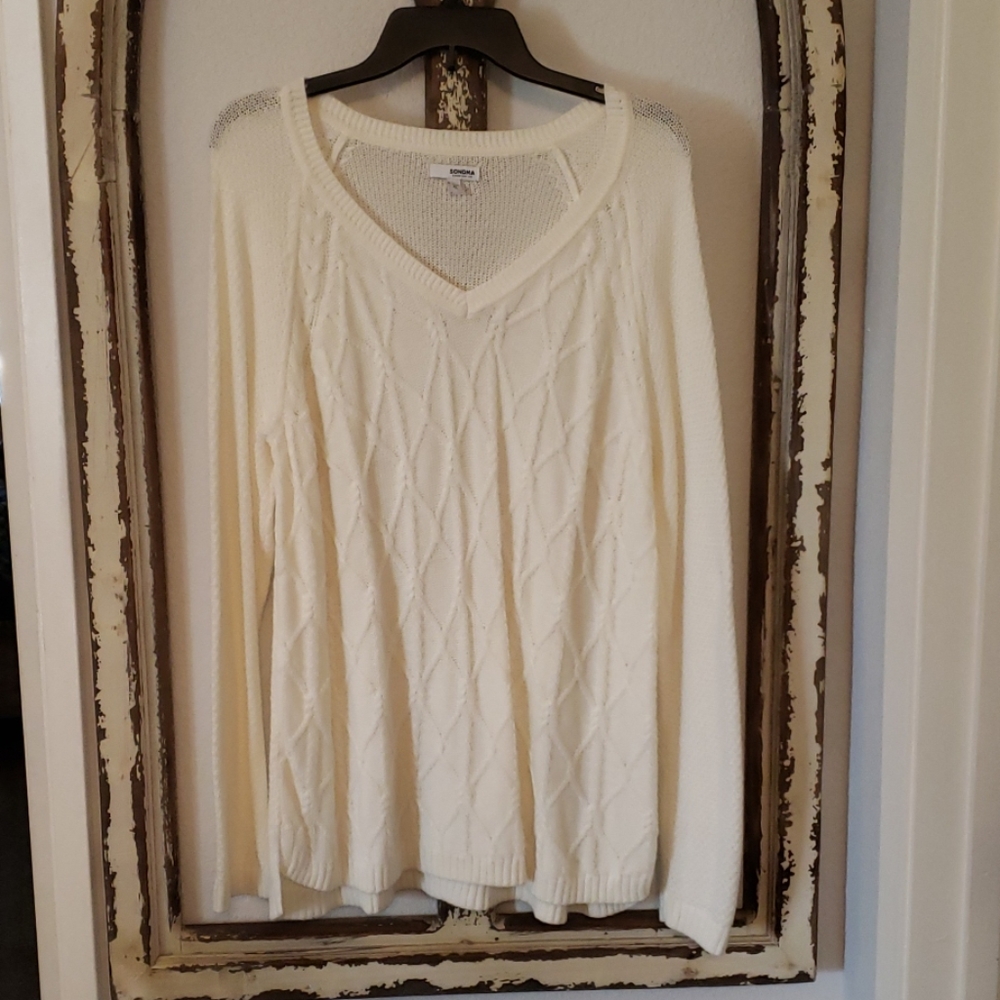Long sleeved cableknit sweater.
